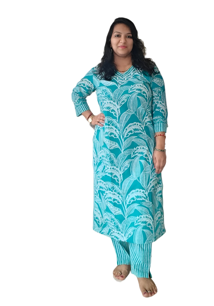 Woman wearing a turquoise patterned outfit on a white background