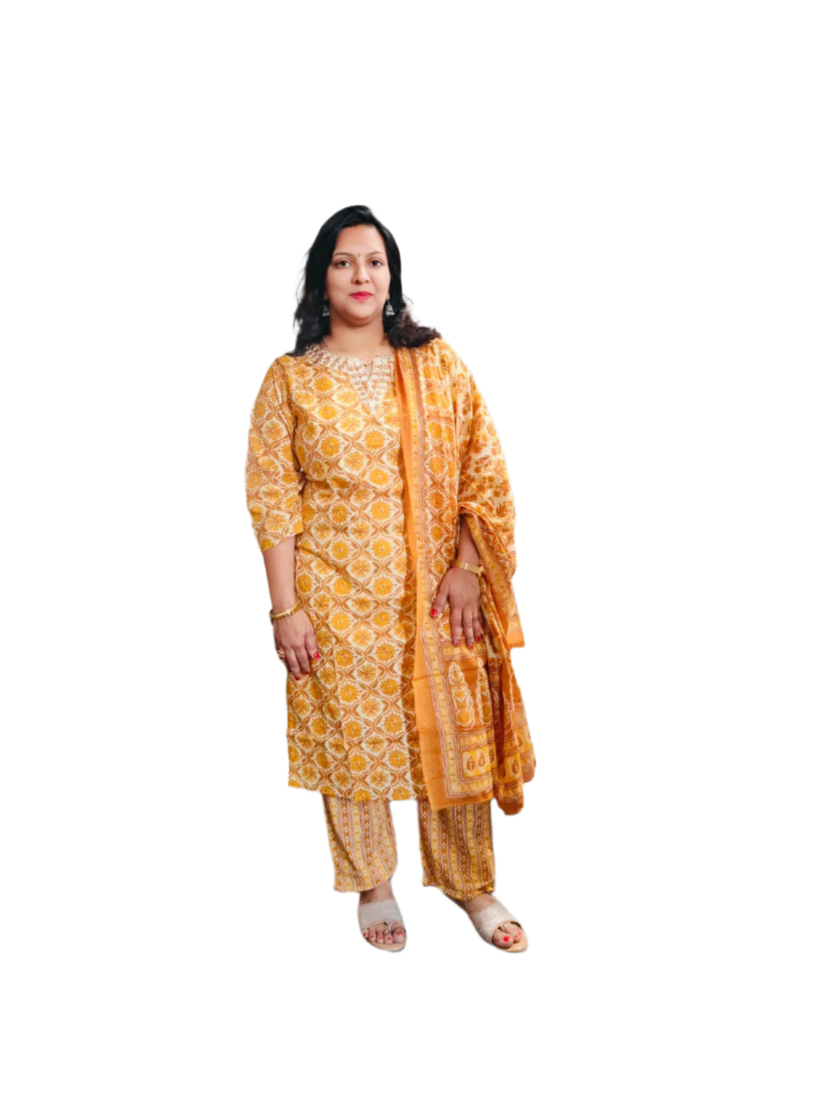 Woman in a yellow traditional outfit standing in a modern building interior.