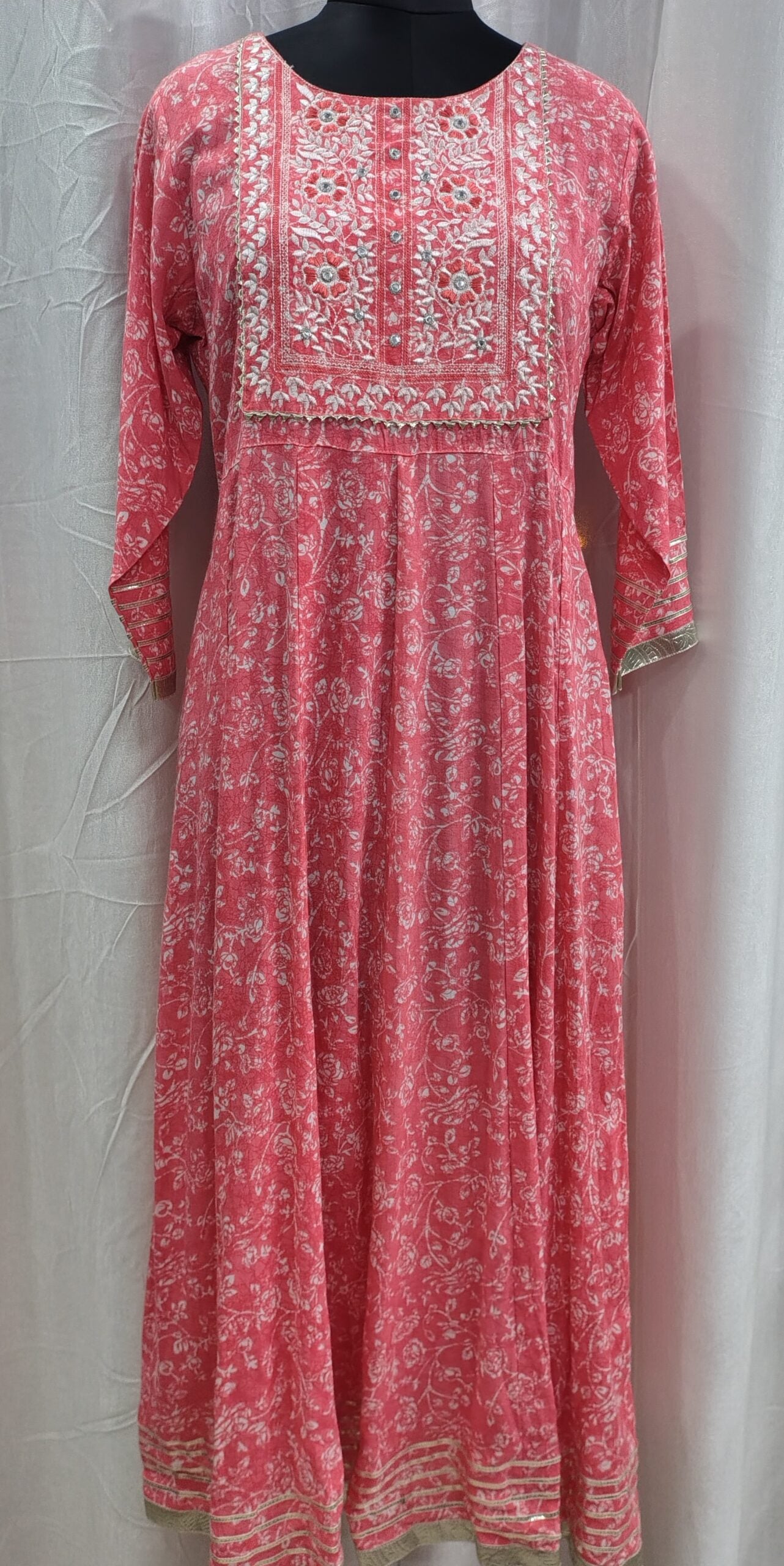 Red floral dress with intricate patterns on a white background